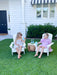 Two young girls sitting in the garden on white children's Adirondack Chairs