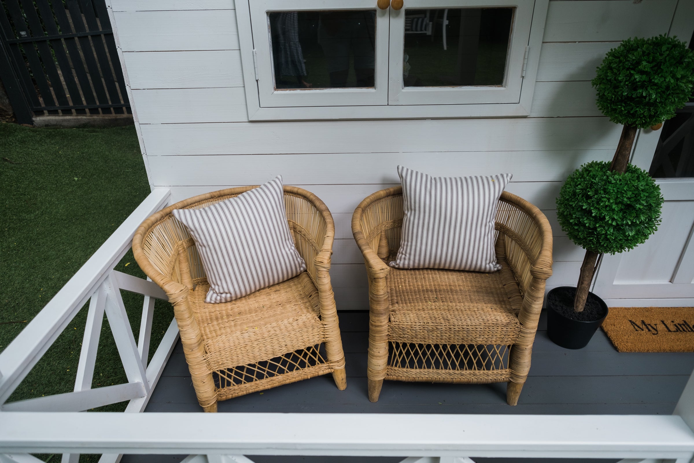 My Little Manor authentic Malawi kids armchairs sit on veranda of white cubby house