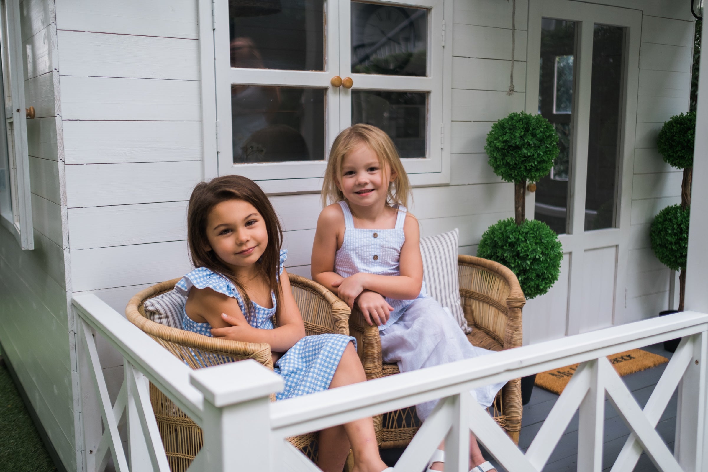 Girls sit on My Little Manor authentic Malawi kids arm chairs