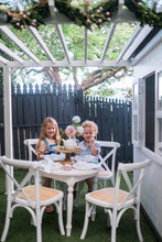 Load image into Gallery viewer, Young bboy and girl sit under cubby house pergola
