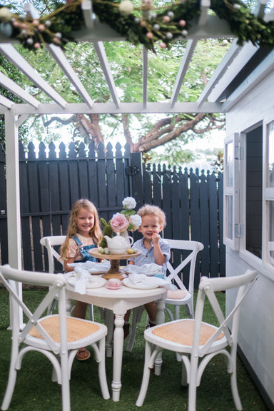 Young bboy and girl sit under cubby house pergola