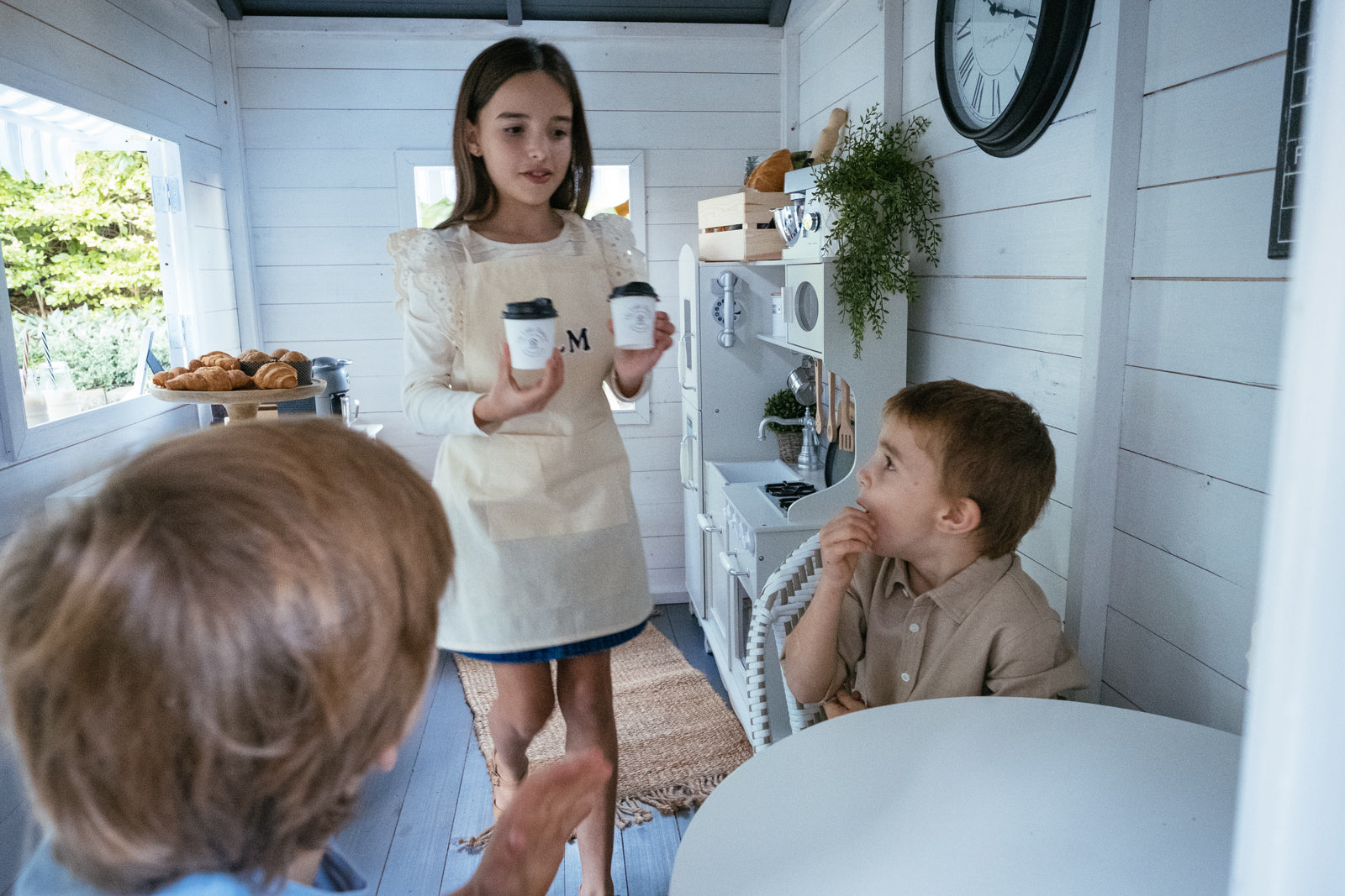 kids playing cafe inside My Little Manor playhouse