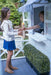 Young boy and girl play cafe in her white timber cubby house