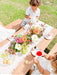 Two young children have a garden tea party using a My Little Manor outdoor table setting