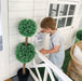 Young boy plays with toy letter box on cubby house