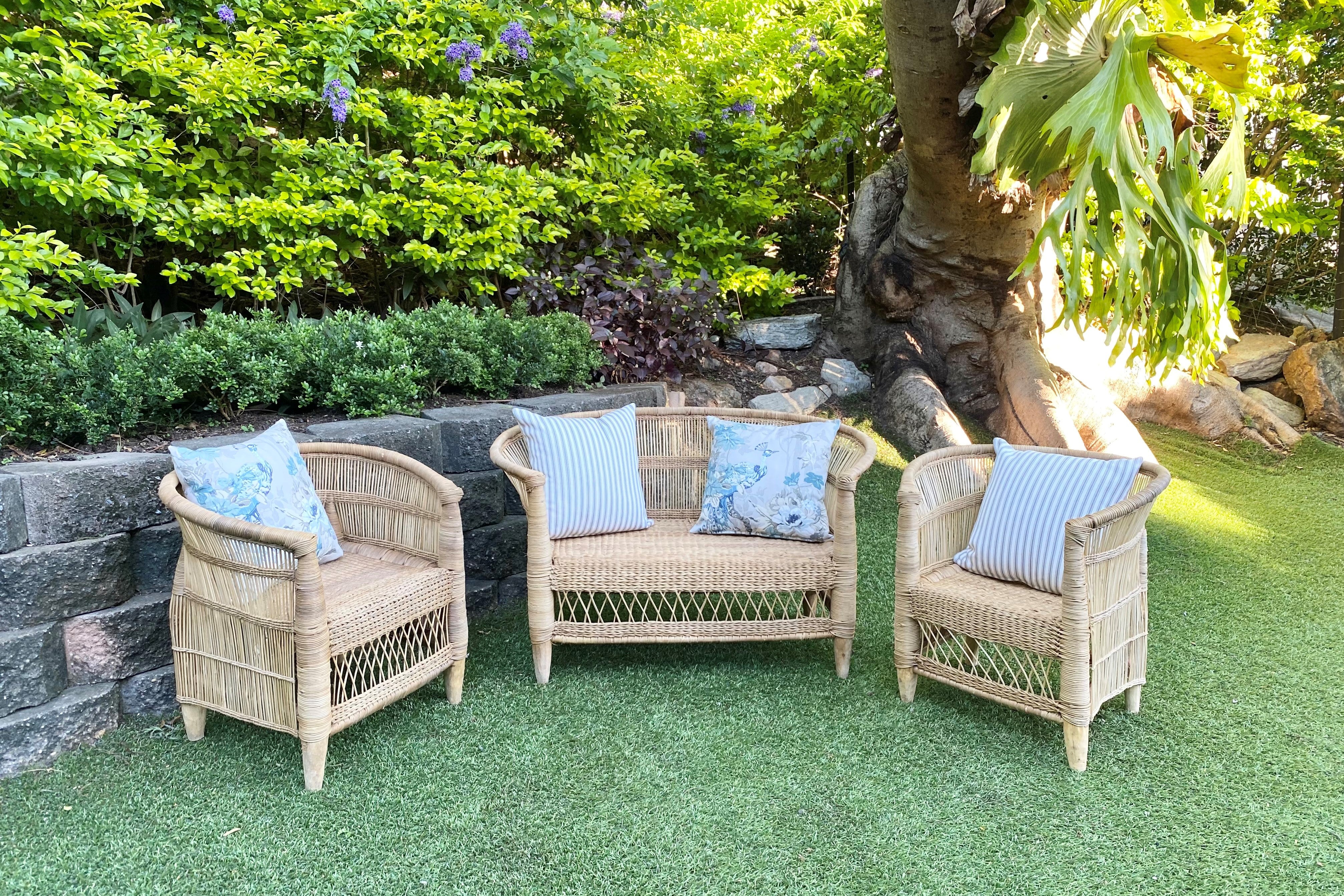 Authentic handmade Malawi arm chairs sit on either side of Malawi two seater chair