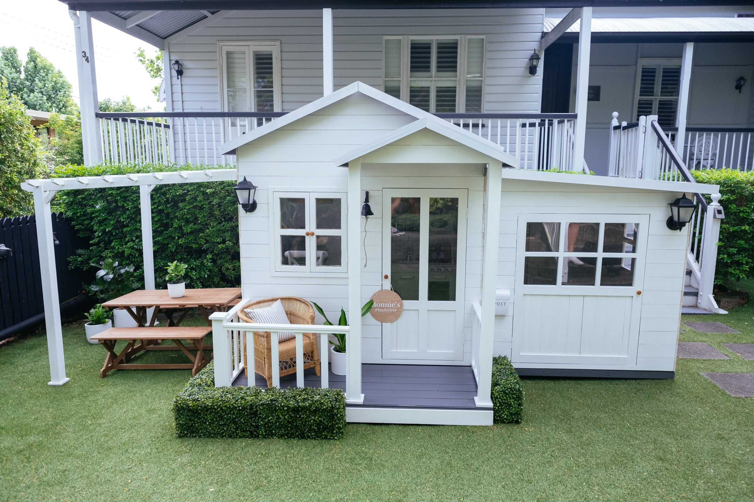  Kids outdoor timber table and bench seat set sit under cubby house pergola