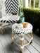 Children's black and white rattan stool with coffee and muffin. Provincial style children's rattan stool