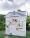 Hamptons timber cubby house painted white with grey roof